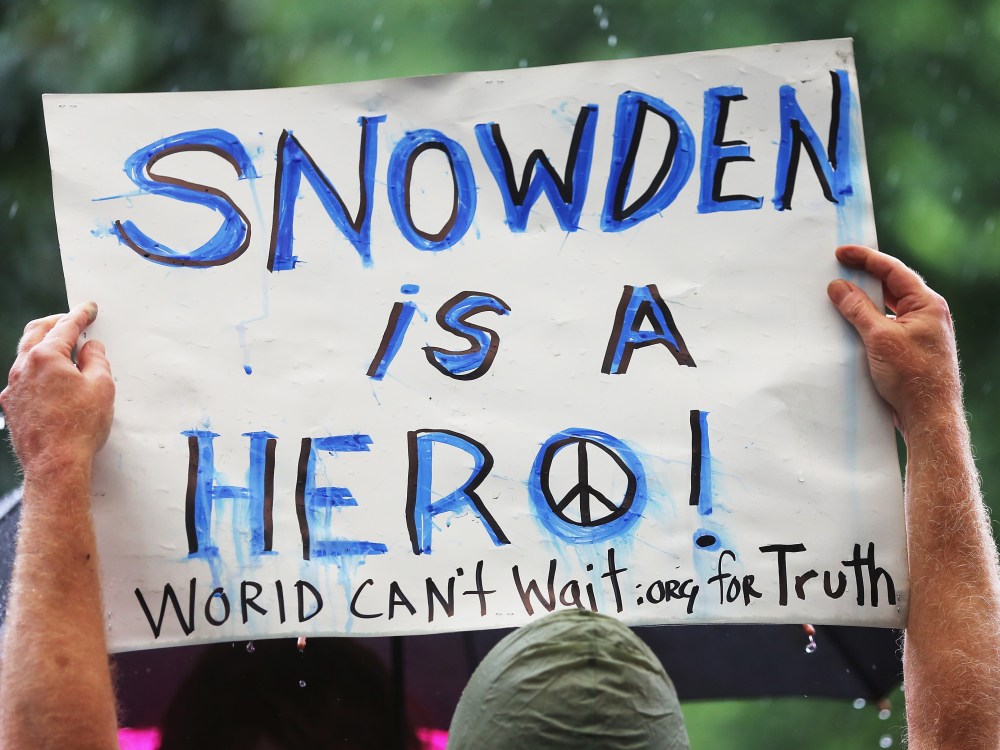 File photo: A supporter holds a sign at a small rally in support of National Security Administration (NSA) whistle-blower Edward Snowden June 10, 2013 in New York City. (Photo by Mario Tama/Getty Images)