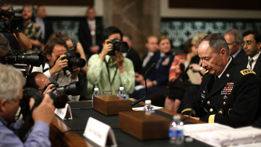 File photo: Army Gen. Keith Alexander, director of the National Security Agency (NSA) is surrounded by photographers after arriving at a Senate Appropriations Committee hearing June 12, 2013.  (Photo by Mark Wilson/Getty Images)