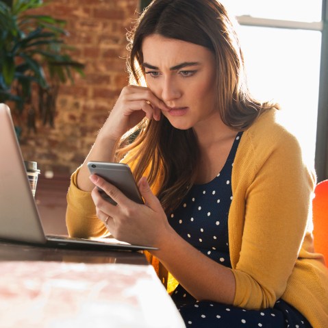 Image: Stressed woman using cell phone