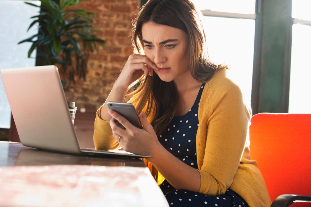 Image: Stressed woman using cell phone