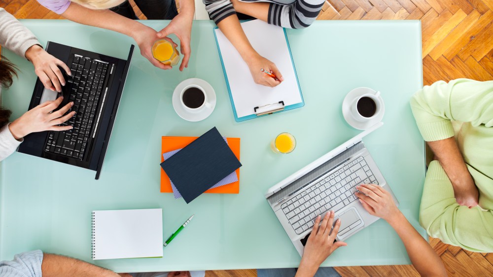 Image: Group of people with two laptops at a meeting