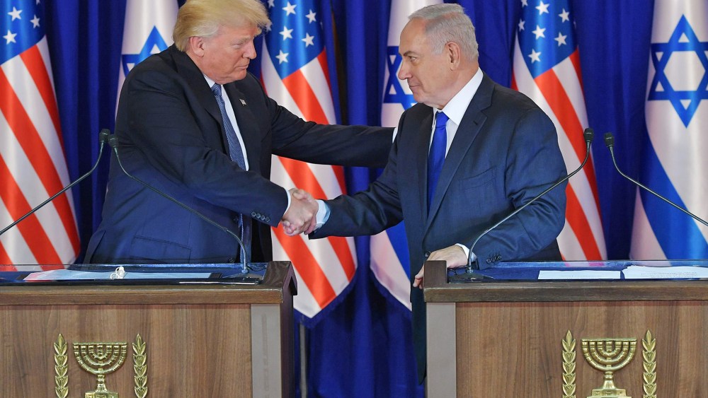 Image: US President Donald Trump (L) and Israel's Prime Minister Benjamin Netanyahu shake hands after delivering press statements