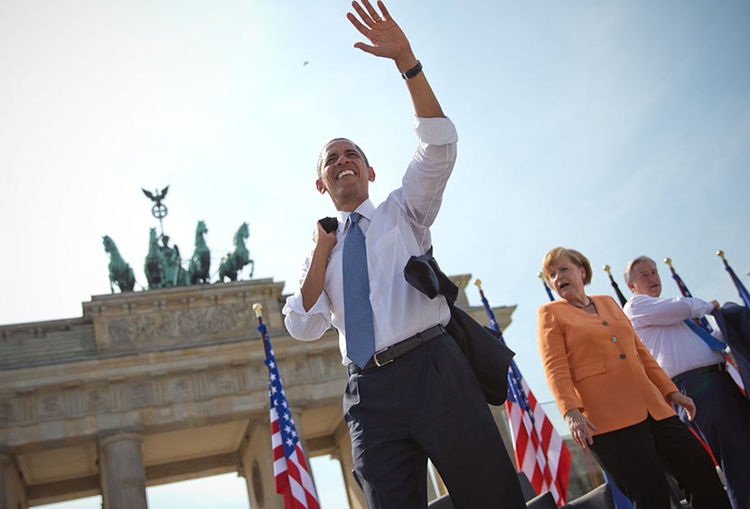 German Chancellor Angela Merkel (C) and Berlin's mayor Klaus Wowereit look on as US President Barack Obama waves to invited guests in front of Berlin's landmark the Brandenburg Gate near the US embassy on June 19, 2013. US President Barack Obama walks...