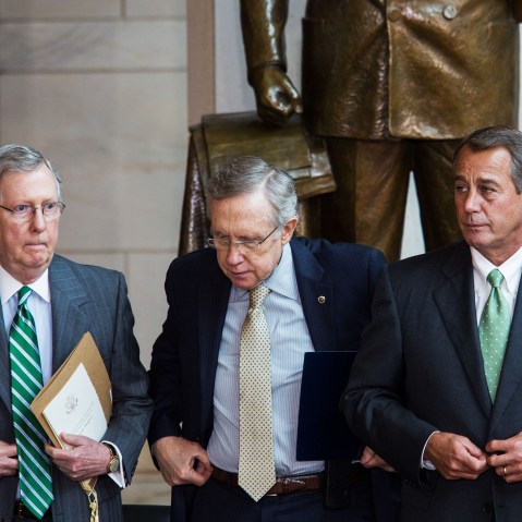 Mitch McConnell, Harry Reid, and John Boehner prepare to take their seats for a dedication ceremony at the U.S. Capitol, June 19, 2013.