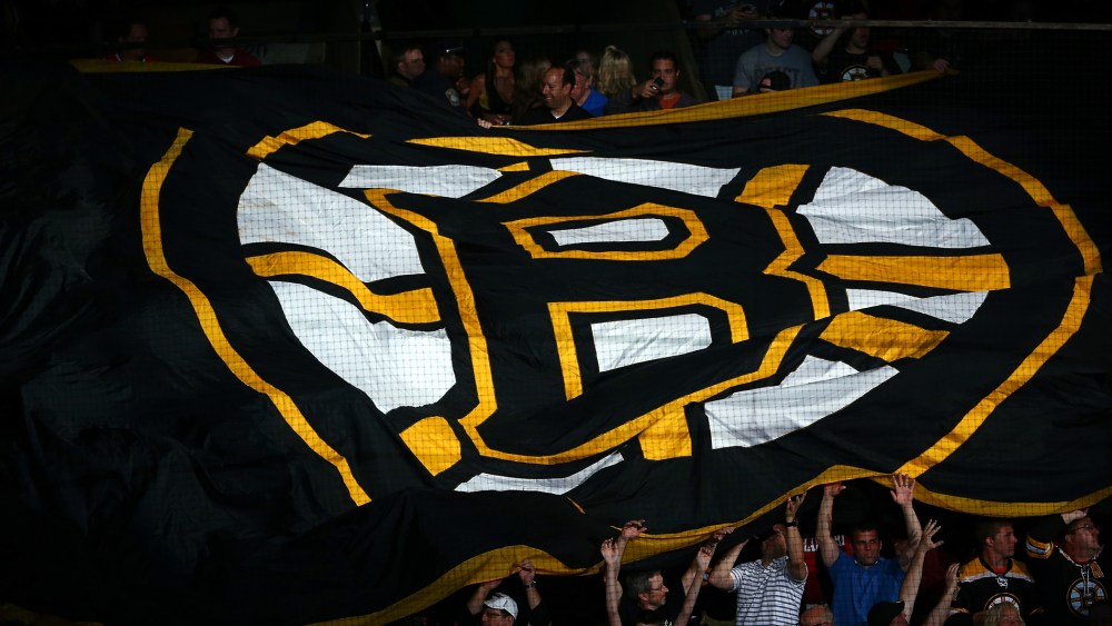 Boston Bruins fans hold a giant flag with the Boston Logo on it prior to a game in Boston, Massachusetts.