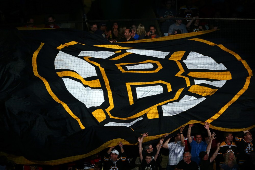 Boston Bruins fans hold a giant flag with the Boston Logo on it prior to a game in Boston, Massachusetts.