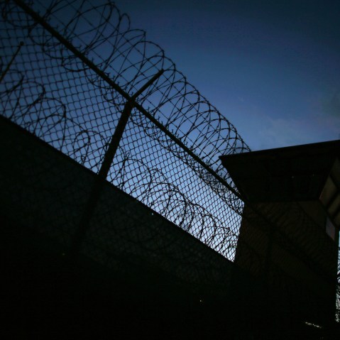 Razor wire is seen near the guard tower at the entrance to Camp V and VI at the U.S. military prison for 'enemy combatants' on June 26, 2013 in Guantanamo Bay, Cuba. (Photo by Joe Raedle/Getty)