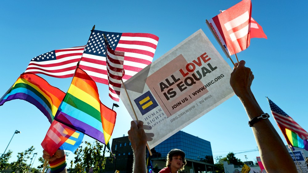 Same-sex marriage supporters celebrate the US Supreme Court ruling during a community rally on June 26, 2013