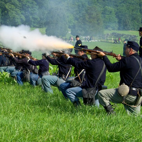 Union soldiers fire a volley at Confederate troops during re-enactment of the Battle of Gettysburg on June 28, 2013.