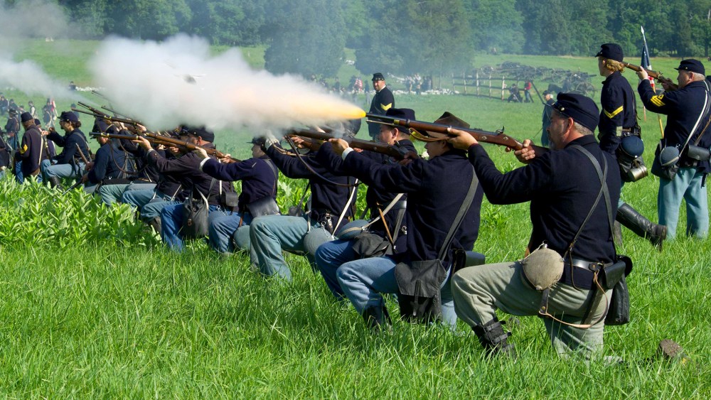Union soldiers fire a volley at Confederate troops during re-enactment of the Battle of Gettysburg on June 28, 2013.