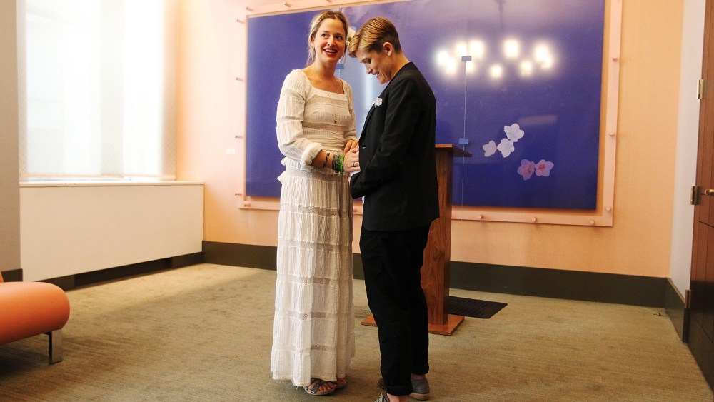 Stefanie Berks (L) touches Daisy Boyd's pregnant belly before their marriage ceremony at the Manhattan Marriage Bureau two days after the U.S. Supreme Court ruling on DOMA on June 28, 2013 in New York City.