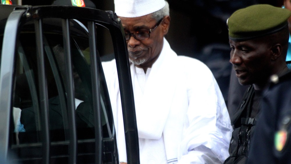 Former Chadian dictator Hissene Habre, charged with genocide, war crimes, torture and crimes against humanity, is escorted by military officers after being heard by judge on July 2, 2013 in Dakar. (Photo by STRINGER/AFP/Getty)