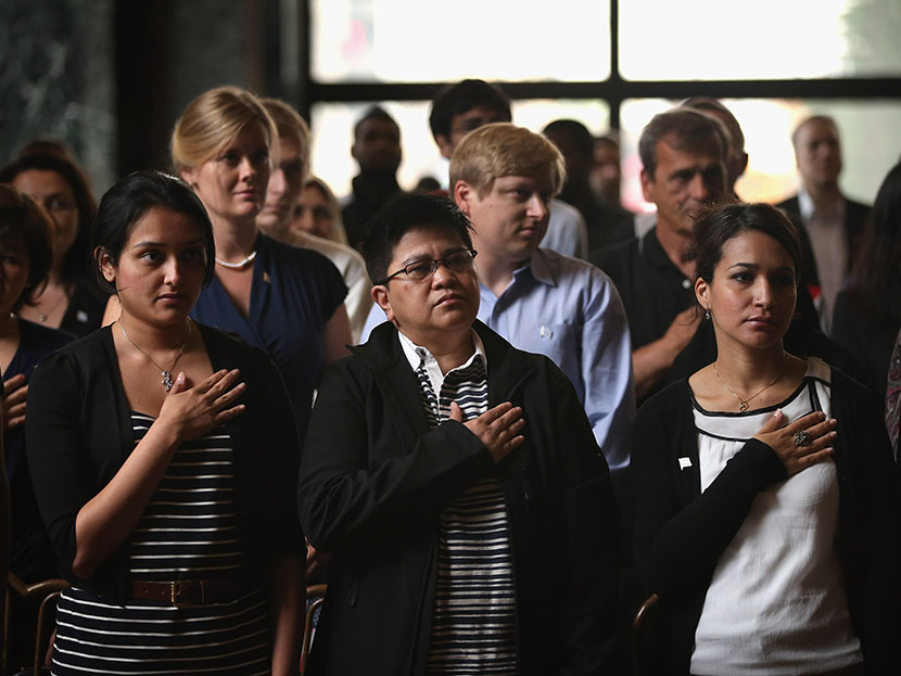 New U.S. citizens recite the Pledge of Allegiance during a naturalization ceremony at the Chicago Cultural Center on July 3, 2013. (Photo by Scott Olson/Getty)
