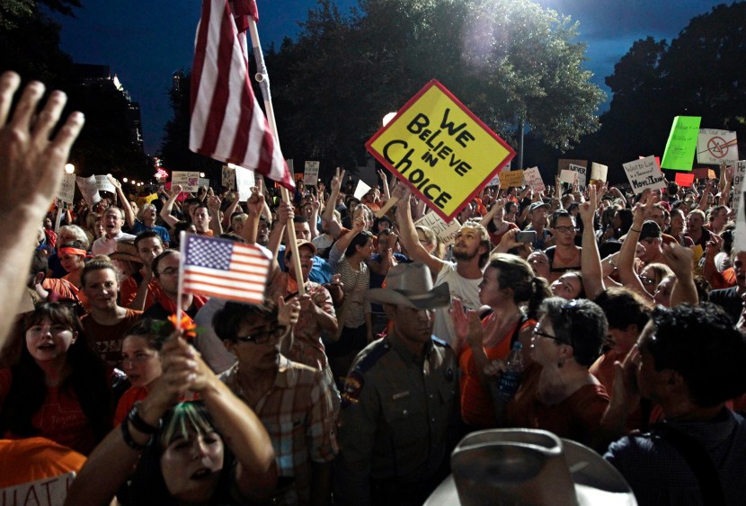 Pro-life supporters and pro-choice protesters rally at the Texas state capitol in favor and against the new controversial abortion legislation up for a vote in the state legislature on July 8, 2013 in Austin Texas. (Photo by Erich Schlegel/Getty Images)