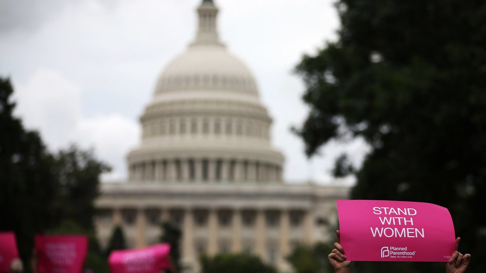 Women hold up signs during a women's pro-choice rally on Capitol Hill, July 11, 2013 in Washington, DC.