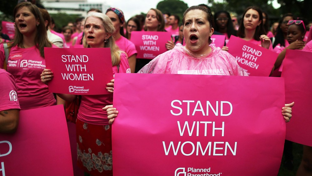 Women hold up signs during a women's pro-choice rally on Capitol Hill, July 11, 2013.