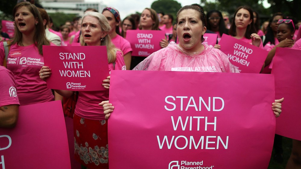 Women hold up signs during a women's pro-choice rally on Capitol Hill, July 11, 2013 in Washington, DC.