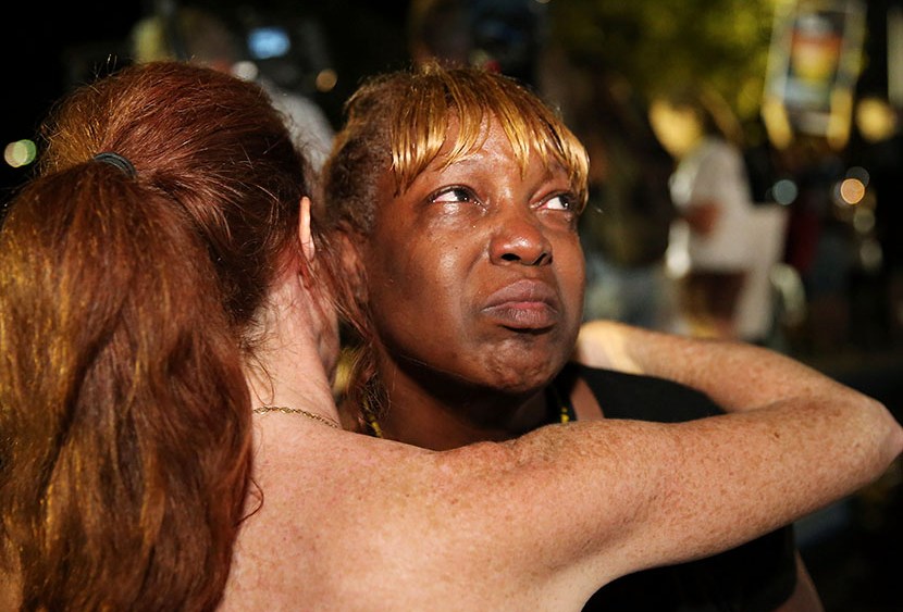 Tanetta Foster is comforted by Erika Rodgers (L) after she breaks into tears in front of the Seminole County Criminal Justice Center after learning George Zimmerman had been found not guilty in the Murder of Trayvon Martin on July 13, 2013 in Sanford,...