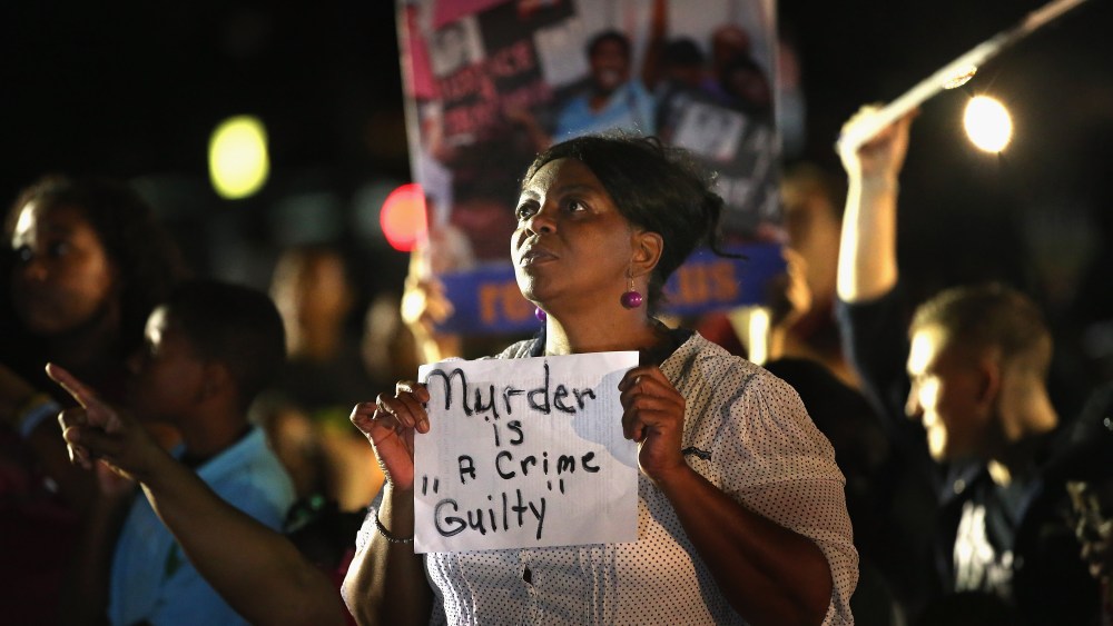 SANFORD, FL - JULY 13:  Supporters of Trayvon Martin wait in front of the Seminole County Criminal Justice Center for the verdict to be announced in the George Zimmerman murder trial on July 13, 2013 in Sanford, Florida. The jury found Zimmerman, a...