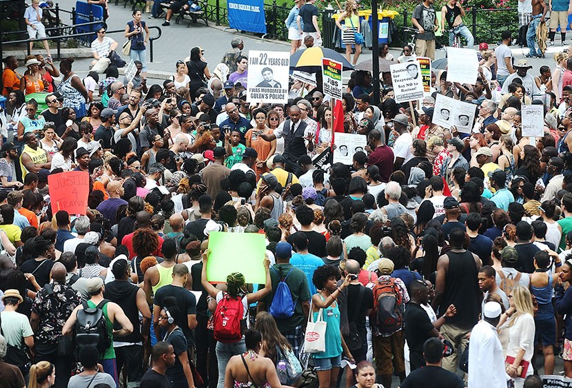 People gather at a rally honoring Trayvon Martin at Union Square in Manhattan on July 14, 2013 in New York City.  (Photo by Mario Tama/Getty Images)