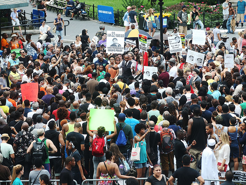 People gather at a rally honoring Trayvon Martin at Union Square in Manhattan on July 14, 2013 in New York City.  (Photo by Mario Tama/Getty Images)