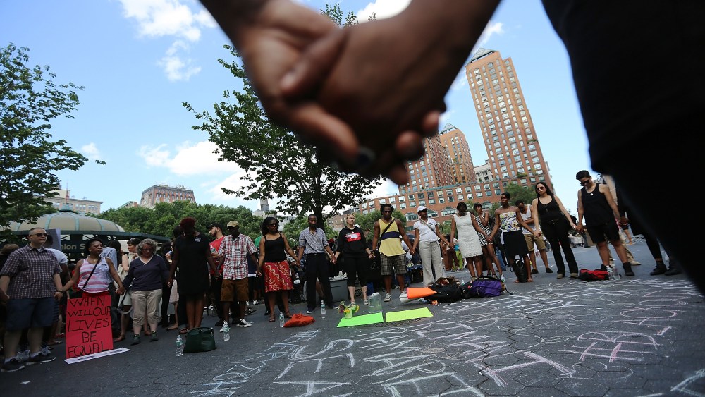 NEW YORK, NY - JULY 14:  People hold hands in a circle at a rally honoring Trayvon Martin at Union Square in Manhattan on July 14, 2013 in New York City. George Zimmerman was acquitted of all charges in the shooting death of Martin July 13 and many...