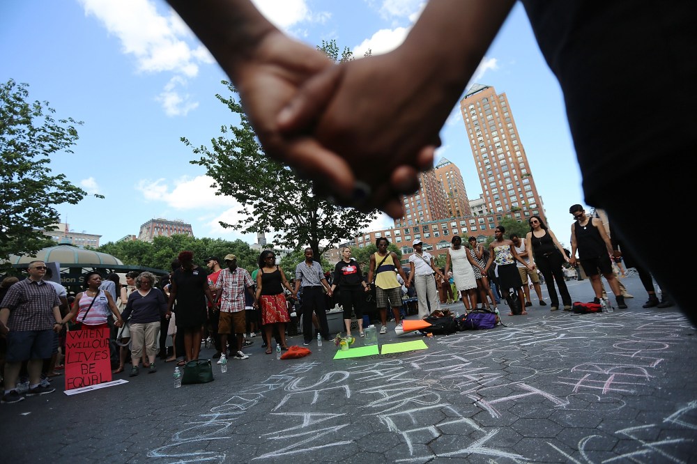 NEW YORK, NY - JULY 14:  People hold hands in a circle at a rally honoring Trayvon Martin at Union Square in Manhattan on July 14, 2013 in New York City. George Zimmerman was acquitted of all charges in the shooting death of Martin July 13 and many...