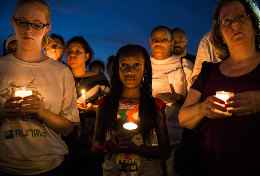 Aaliyah Wright, 9, participates in a candle lit vigil for Trayvon Martin, the teenager who was shot and killed in Florida last year, on July 15, 2013 in New York City. (Photo by Andrew Burton/Getty Images)