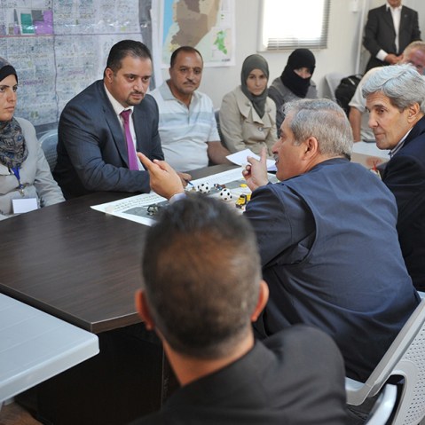 US Secretary of State John Kerry (C-R) and his Jordanian counterpart Nasser Judeh (C) meet with Syrian refugees at the Zaatari refugee camp near the Jordanian city of Mafraq on July 18, 2013.  (Photo by Mandel Ngan/AFP/Getty Images/Pool)