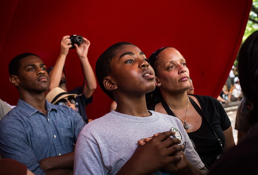A boy cranes his head to hear a speaker while attending a rally in support of Trayvon Martin, organized by the Reverand Al Sharpton, in response to the non-guilty verdict for George Zimmerman on July 20, 2013 in New York City.  (Photo by Andrew Burton...