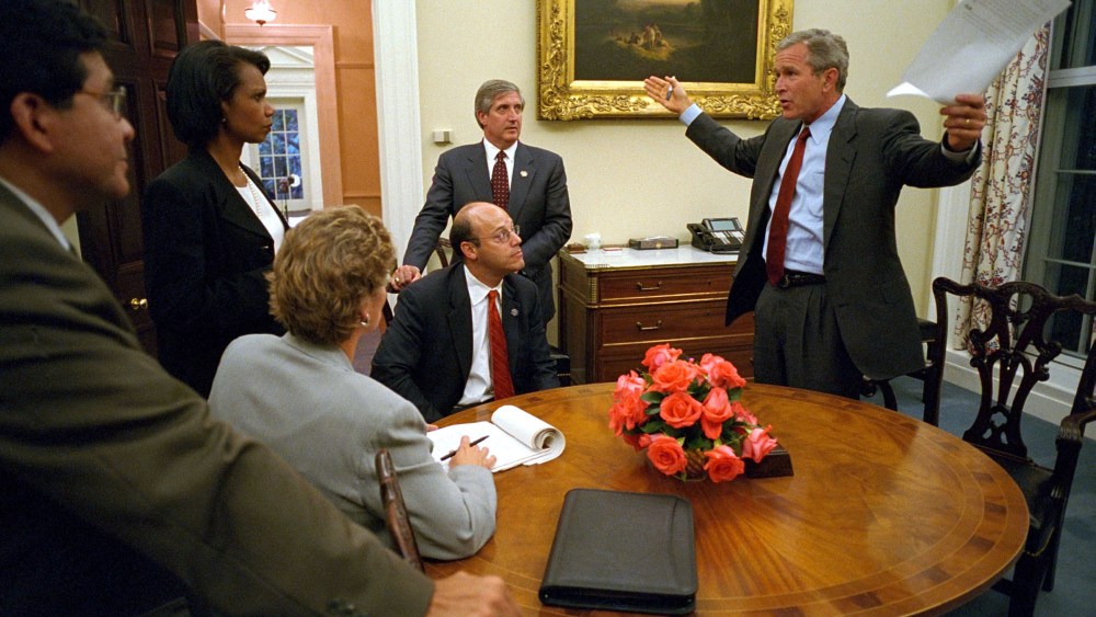 Bush White House Chief of Staff Andy Card listens with other members of the administration to President George W. Bush at The White House prior to his address to the nation about the terrorist attacks on the U.S., September 11, 2001.
