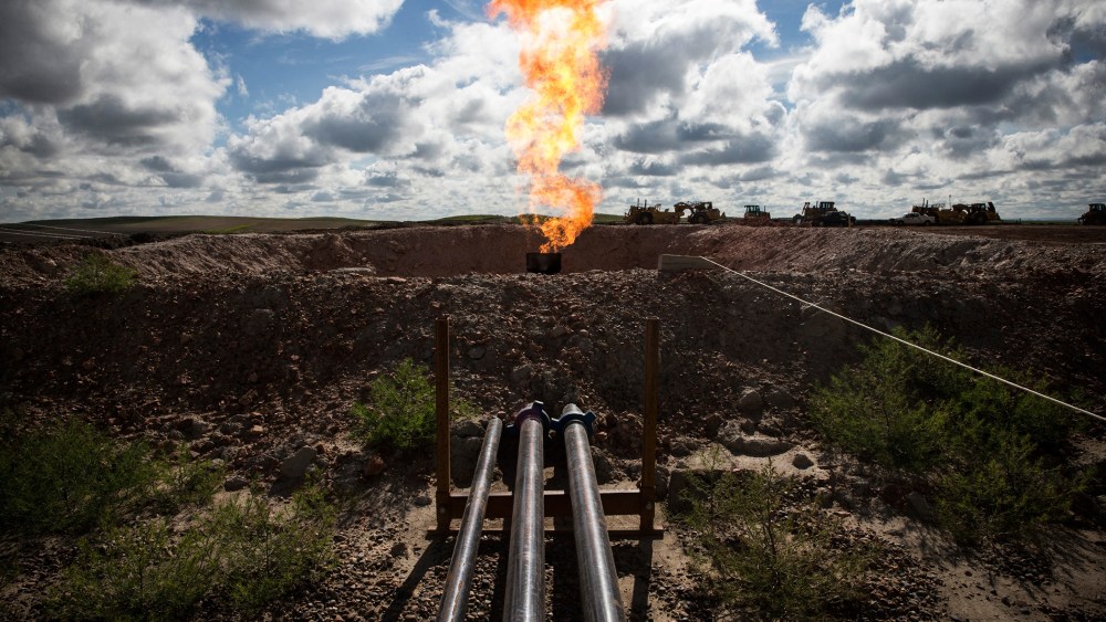 A gas flare is seen at an oil well site on July 26, 2013 outside Williston, N.D.