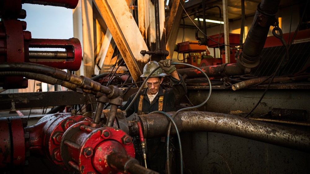 Ray Gerish, a floor hand for Raven Drilling, works on an oil rig drilling into the Bakken shale formation on July 28, 2013 outside Watford City, North Dakota. (Photo by Andrew Burton/Getty)