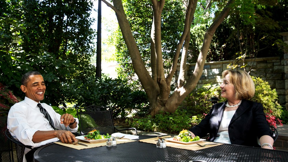 U.S. President Barack Obama has lunch Hillary Rodham Clinton on the patio outside the Oval Office, July 29, 2013.