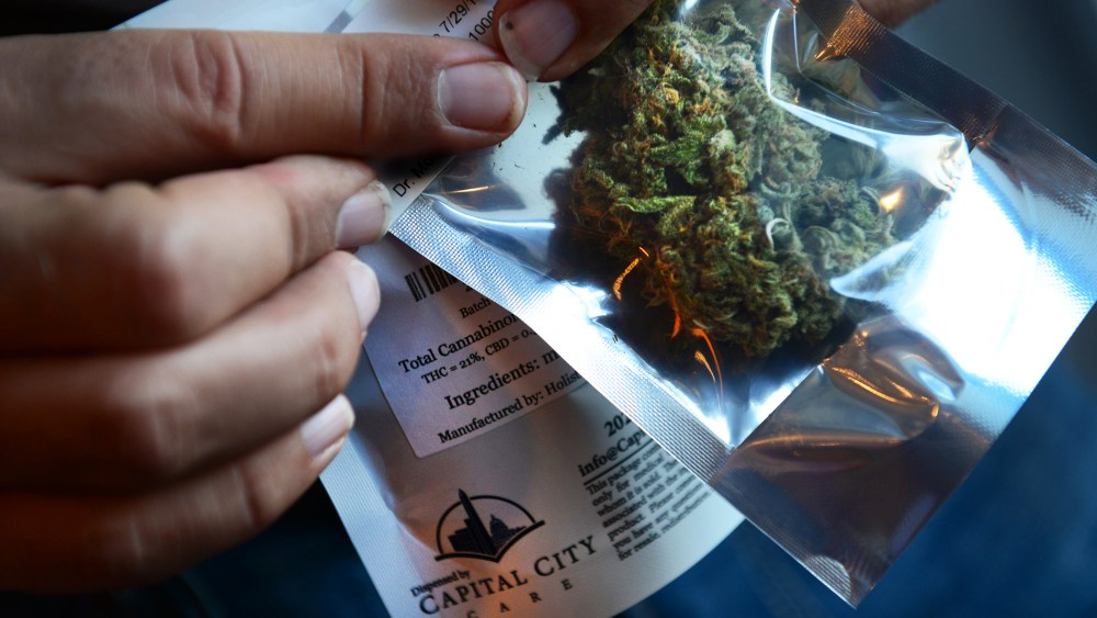 A man purchases medical marijuana at Capital City Care in Washington, DC, July 29, 2013.