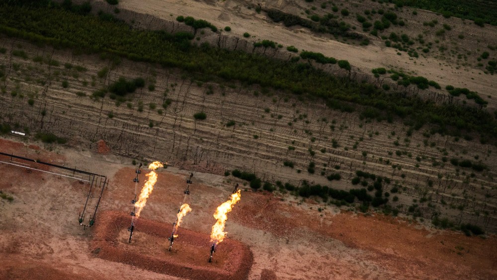 A gas flare is seen in an aerial view in the early morning hours of July 30, 2013 near Watford City, North Dakota.