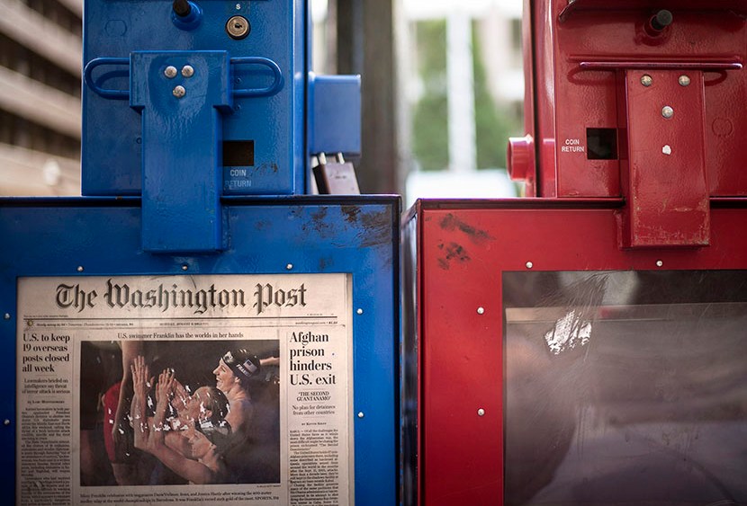 A Washington Post newspaper box (L) stands beside the empty box of competitor Washington Times (R) outside the Washington Post on August 5, 2013 in Washington, DC, after it was announced that Amazon.com founder and CEO Jeff Bezos had agreed to purchase...