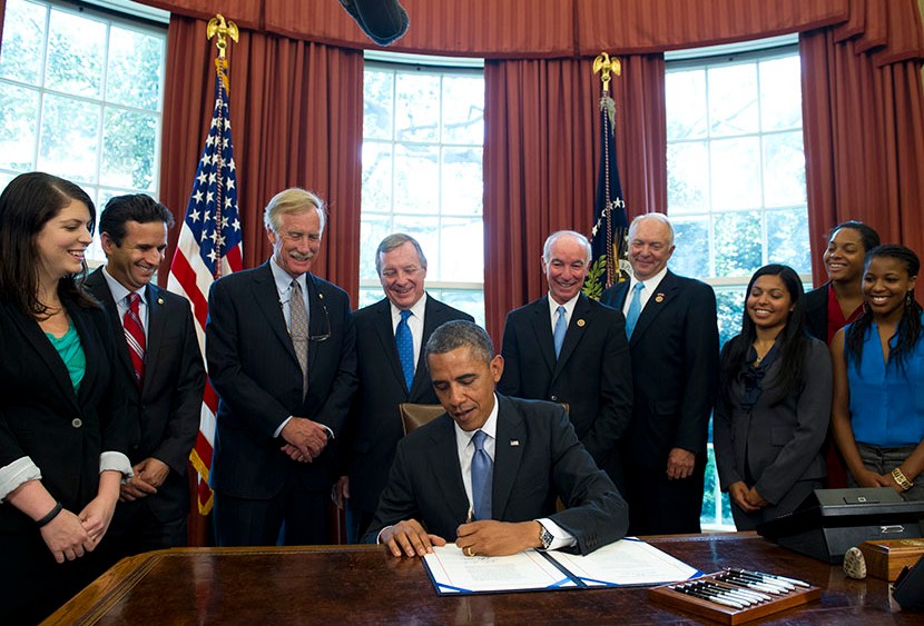 US President Barack Obama signs a student loan bill to keep students' interest rates low during a signing ceremony in the Oval Office of the White House in Washington, DC, on Aug. 9, 2013. (Photo by Saul Loeb/AFP/Getty)