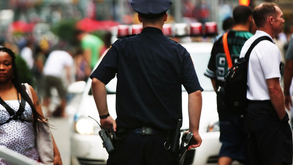 A New York City police officer stands in Times Square on August 12, 2013 in New York City.