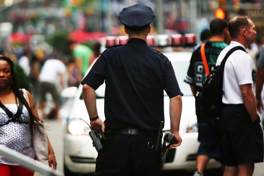 A New York City police officer stands in Times Square on August 12, 2013 in New York City.