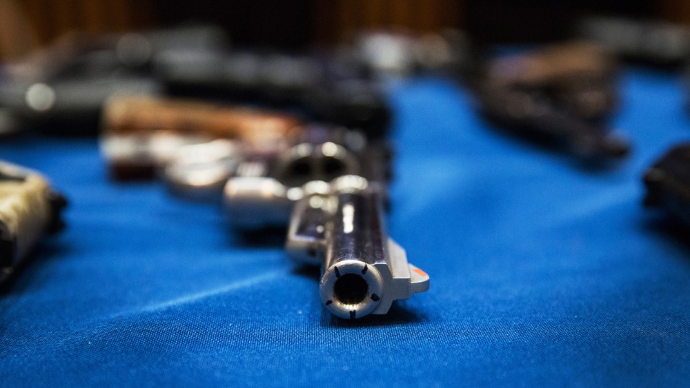 Guns seized by the New York Police Department are displayed during a press conference, August 19, 2013.