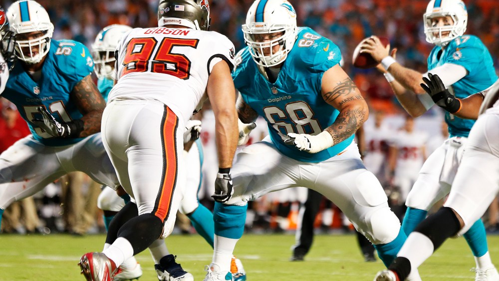 Richie Incognito #68 of the Miami Dolphins battles Gary Gibson #95 of the Tampa Bay Buccaneers during a preseason game, Aug. 24, 2013.