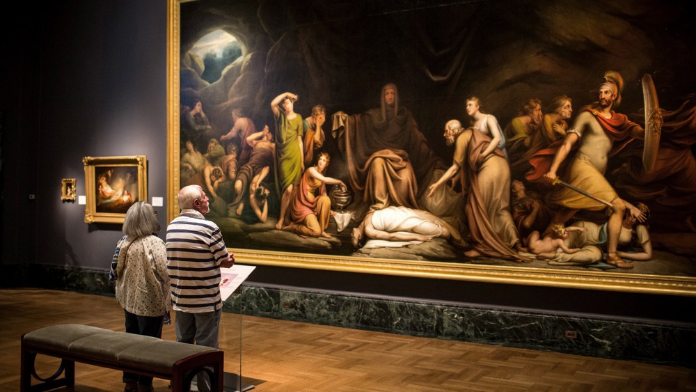 A couple looks at a painting at the Detroit Institute of Arts (DIA) on Sept. 3, 2013 in Detroit, Michigan.