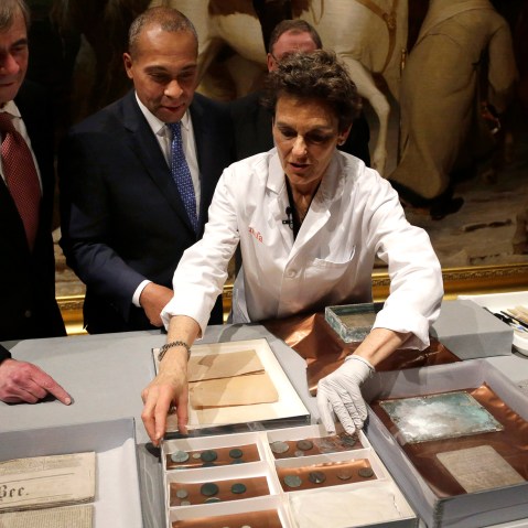 Museum of Fine Arts Boston Head of Objects Conservation Pam Hatchfield, right, displays objects removed a time capsule, Jan. 6, 2015. (Photo by Steven Senne/AP)