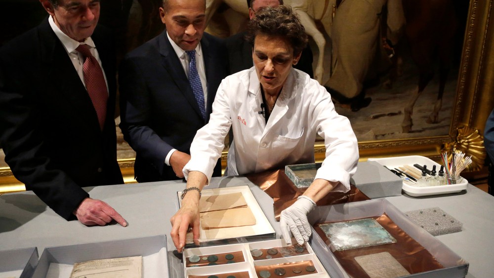 Museum of Fine Arts Boston Head of Objects Conservation Pam Hatchfield, right, displays objects removed a time capsule, Jan. 6, 2015. (Photo by Steven Senne/AP)