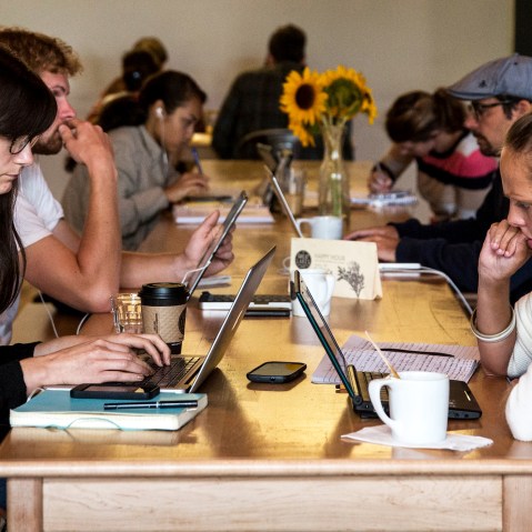 Customers work on their laptops at Great Lakes Coffee Roasting Company on September 6, 2013 in Detroit, Michigan.