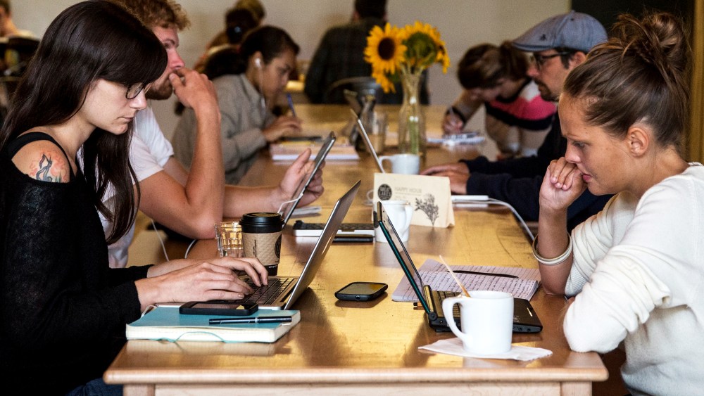 Customers work on their laptops at Great Lakes Coffee Roasting Company on September 6, 2013 in Detroit, Michigan.