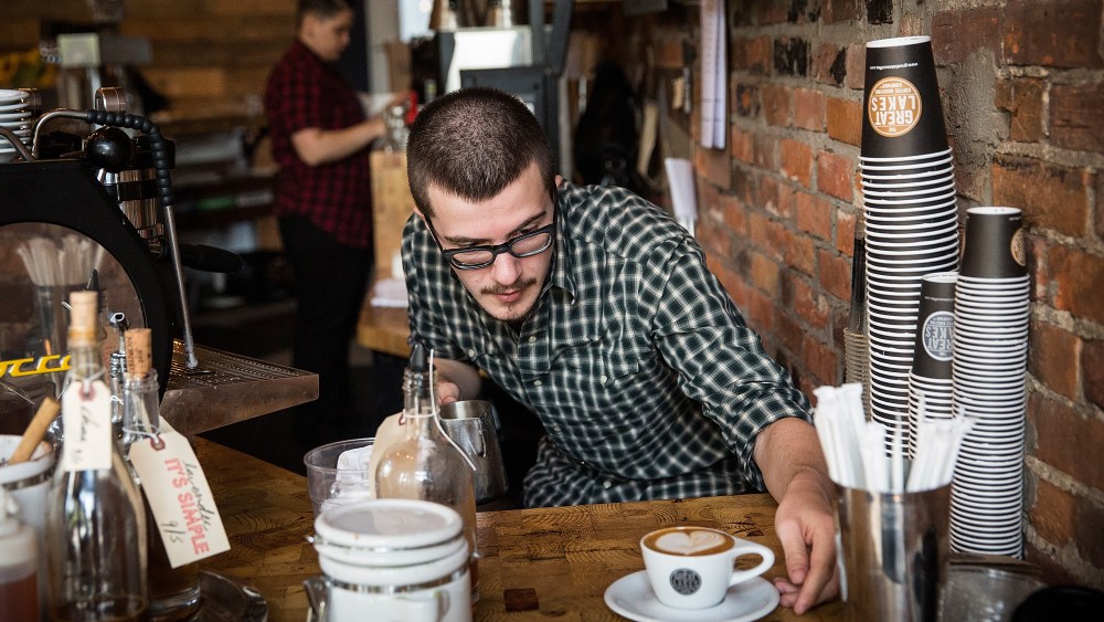 A barista at Great Lakes Coffee Roasting Company, prepares a latte over Labor Day in Detroit.