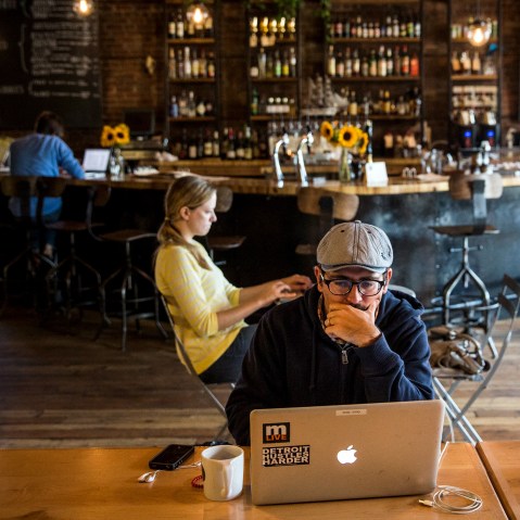 A customer works on his laptop at Great Lakes Coffee Roasting Company in Detroit, Michigan, Sept. 6, 2013.