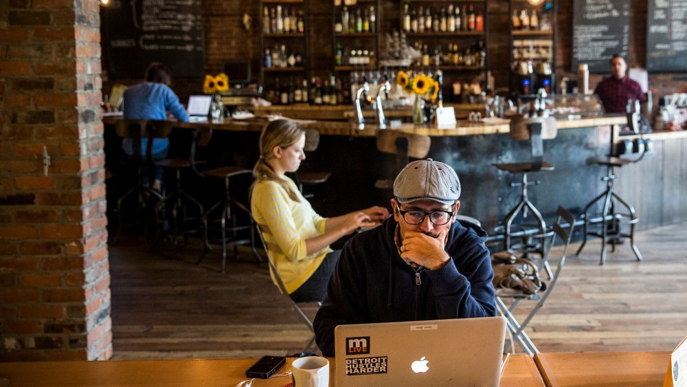 A customer works on his laptop at Great Lakes Coffee Roasting Company in Detroit, Michigan, Sept. 6, 2013.